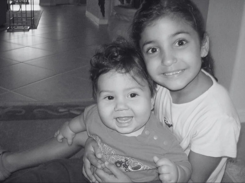 Two young siblings smiling